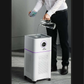 Hospital-Grade HEPA 13 air purifier and humidifier in white with purple trim, filled with water from a clear jug