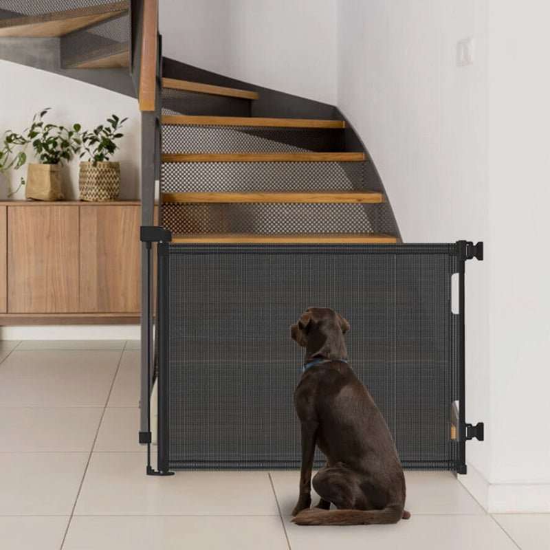 Retractable Safety Gate for Baby & Dog with dark gray mesh fabric, black frame and side pull handle across stairs