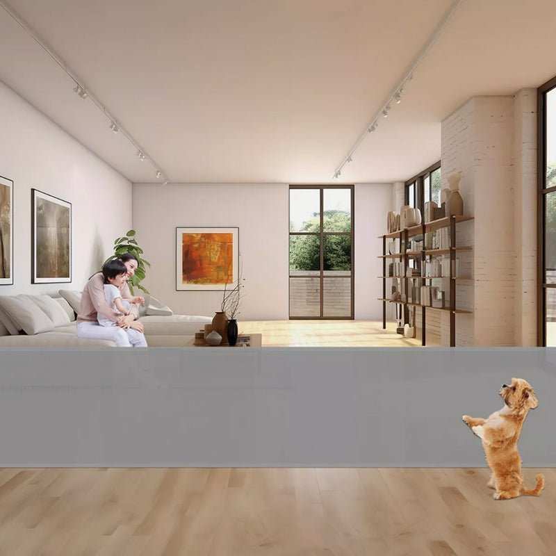 Retractable Safety Gate for Baby & Dog with wide gray mesh panel, spanning a living room opening near a child and dog