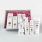 VC Dark Spot Whitening Set with white Vitamin C skincare bottles and boxes, featuring gold labels and pink filler in a gift box.