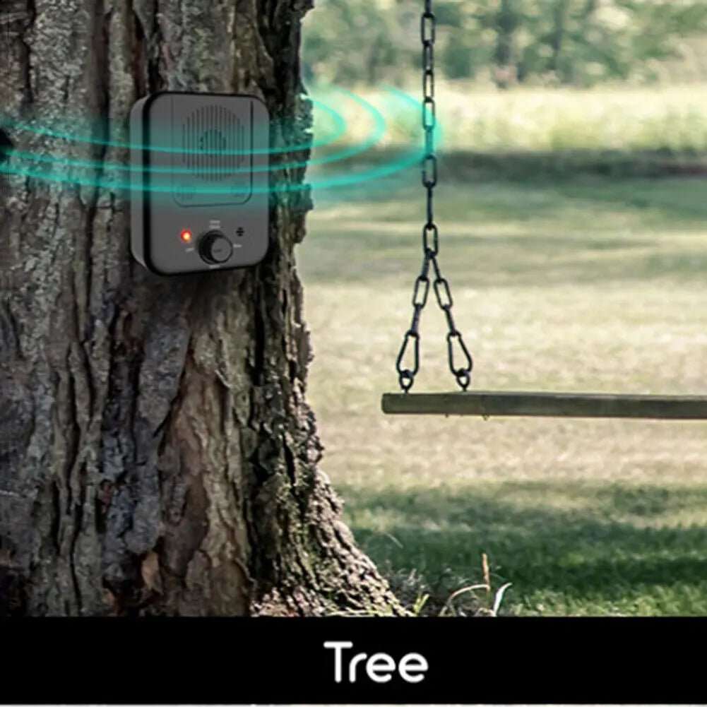 Anti Barking with Ultrasonic device in black plastic, mounted on a tree trunk with a control knob and indicator light