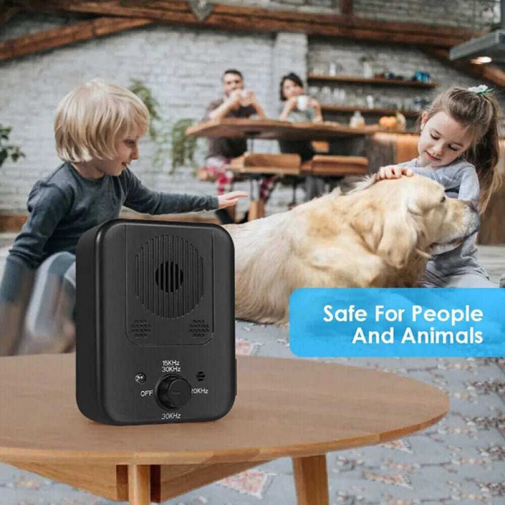 Anti Barking with Ultrasonic device, a black rectangular unit with speaker grille and frequency controls beside a golden dog
