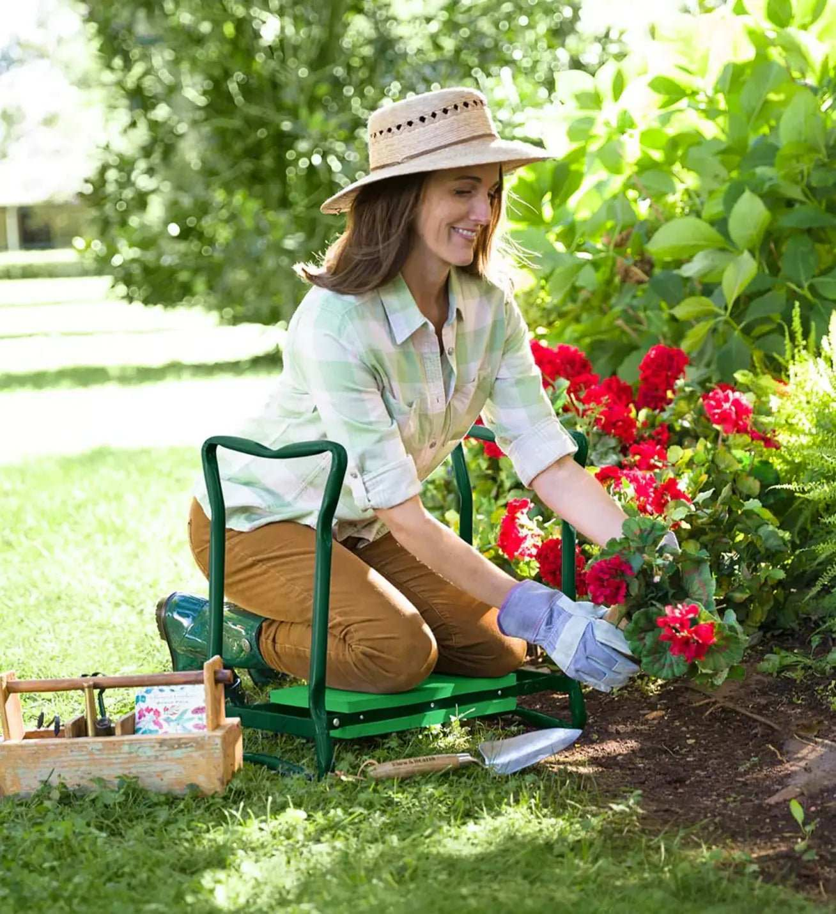 Multipurpose Garden Kneeler With Pockets, a green steel frame with a padded seat and side tool pouch, used while gardening